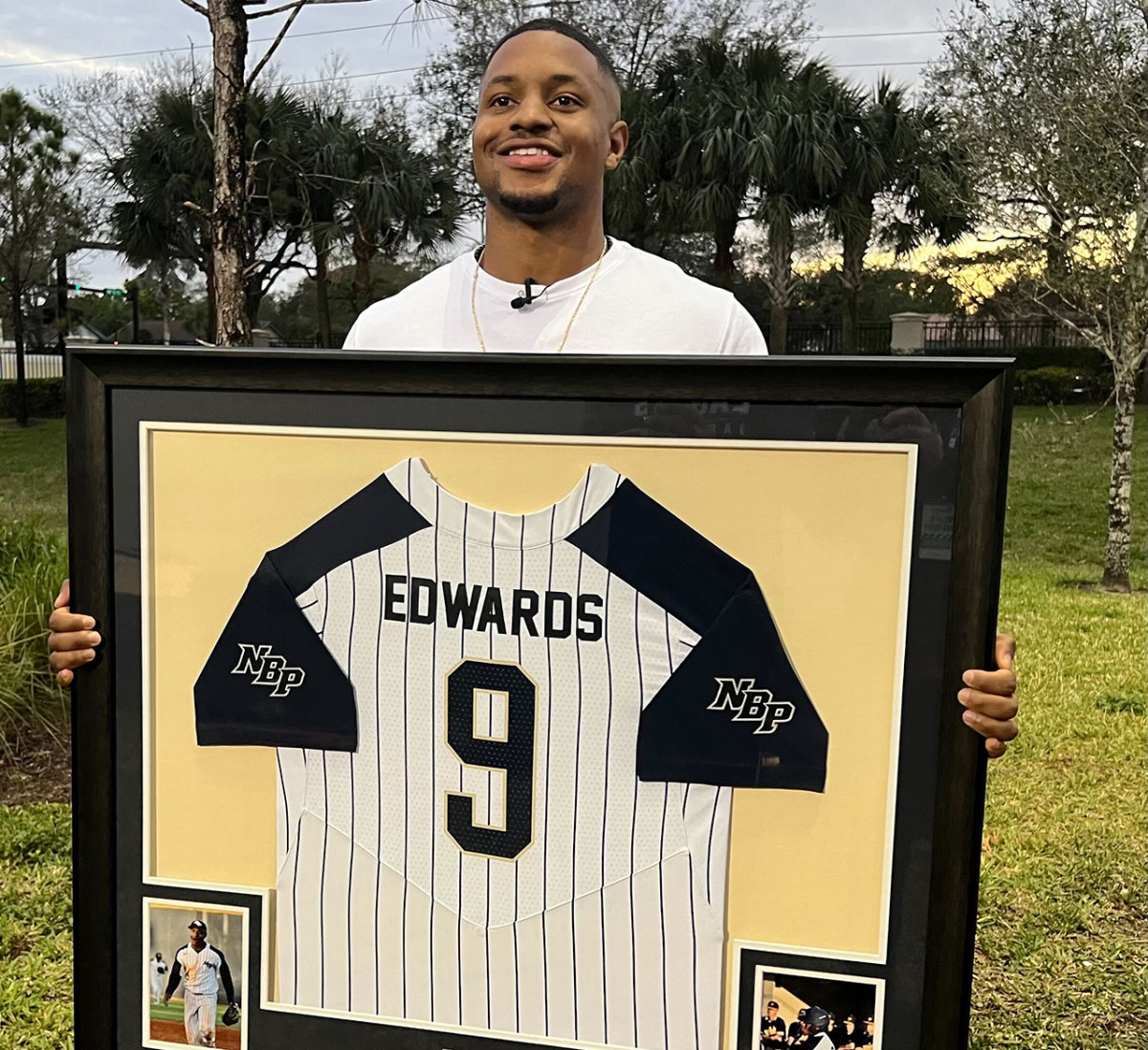 Miami Marlins' infielder Xavier Edwards displays his No. 9 North Broward Prep Jersey, retired by his high school.
